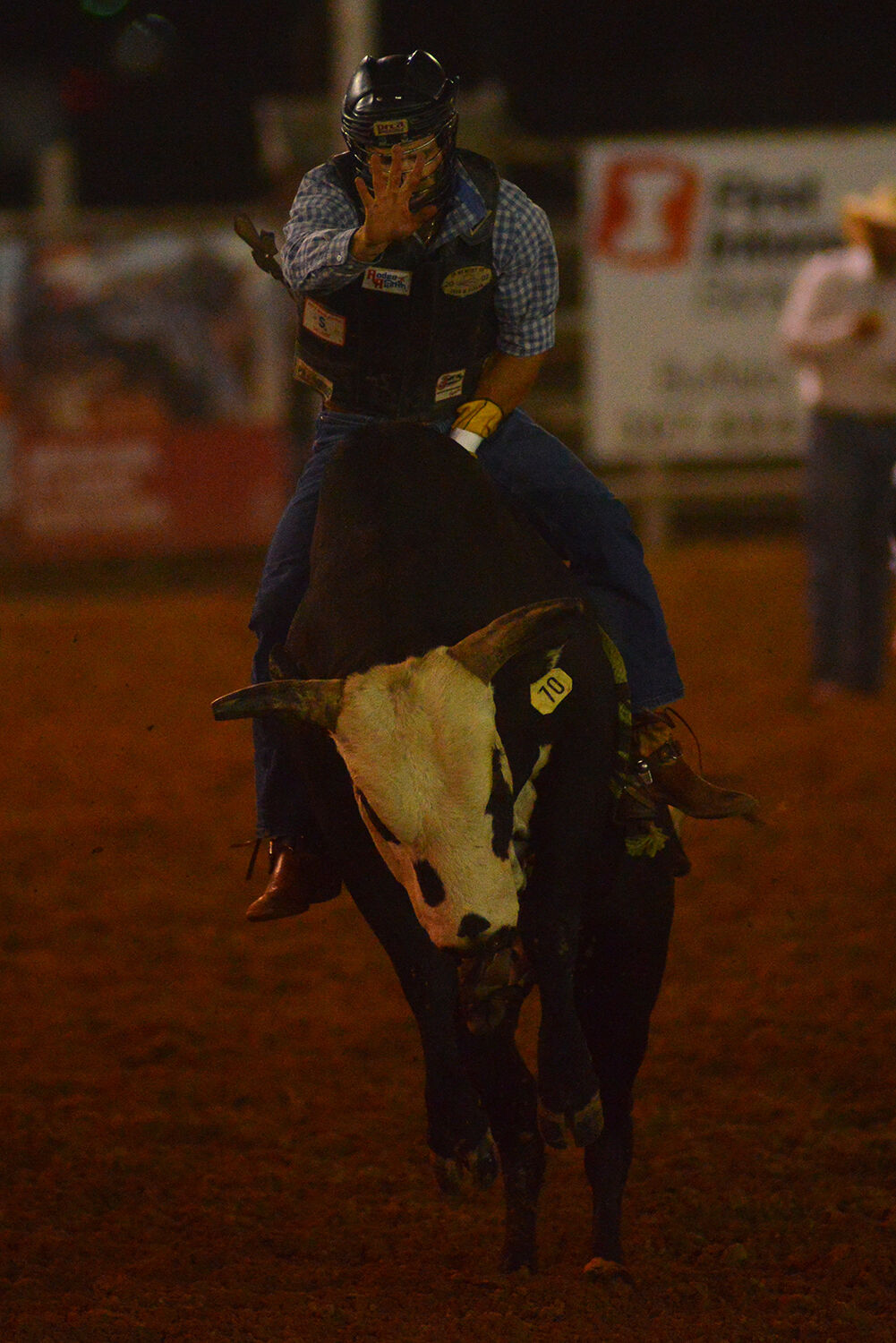 Clayton Savage leans forward as his bull jumps